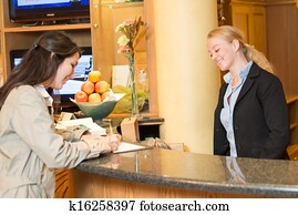 Young woman at the hotel reception Young woman at the hotel reception