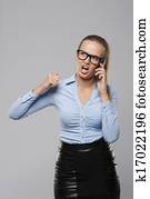 Angry businesswoman shouting into the mobile phone 