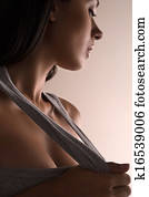 Beautiful woman. Beautiful young girl in stretching out her T-Shirt and looking away