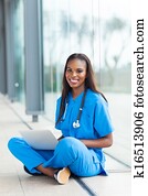 black healthcare worker using laptop