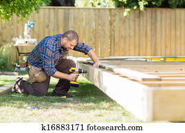 Carpenter Drilling Wood At Construction Site
