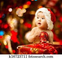 Christmas baby in santa hat near red present gift box Christmas baby in santa hat near red present gift box