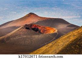 Colorful crater of Etna volcano with Catania in background, Sicily, Italy