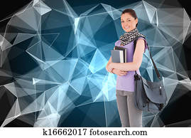 Composite image of attractive student holding books and her bag while standing against a white background