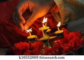 diwali festival of lights , hand lighting an indian oil lamp diwali festival of lights , hand lighting an indian oil lamp