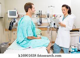 Doctor With Clipboard Discussing Report With Patient