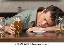 Drink responsibly. Portrait of drunk men sitting at the pub with his eyes closed