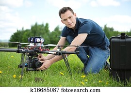 Engineer Setting Camera On Photography Drone