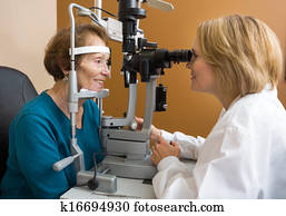Eye Doctor Examining Woman's Vision Eye Doctor Examining Woman's Vision