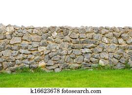 fence real stone wall surface with cement on green grass field