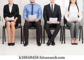 Four candidates competing for one position. Having CV in his hand Four candidates competing for one position. Having CV in his hand