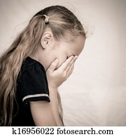 girl covers her face with her hands