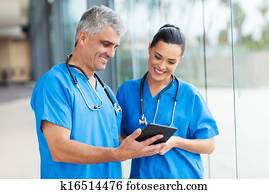 healthcare workers using tablet computer healthcare workers using tablet computer