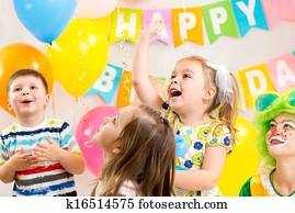 jolly kids group with clown celebrating  birthday party