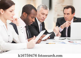 Multi ethnic business people discussing work Multi ethnic business people discussing work