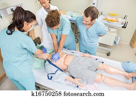 Nurses Performing CPR On Dummy Patient