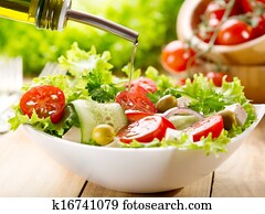 olive oil pouring over salad olive oil pouring over salad