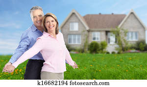 Senior couple near new home.