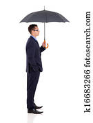 side view of young businesswoman holding umbrella