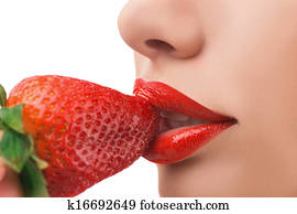 Strawberry. Close-up of woman eating strawberry isolated on white