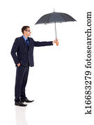 young businessman giving umbrella