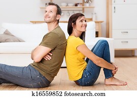 Young couple relaxing on the floor at home