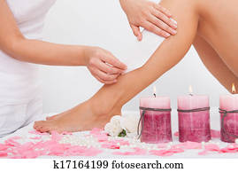 Beautician Waxing A Woman's Leg Beautician Waxing A Woman's Leg