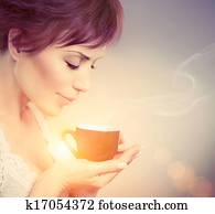 Beautiful Girl Enjoying Coffee. Woman with Cup of Hot Beverage