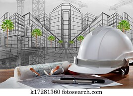 file of safety helmet and architect pland on wood table with sunset scene and building construction