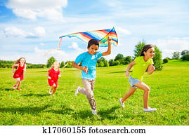 Group of kids run with kite