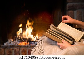 reading book by fireplace reading book by fireplace
