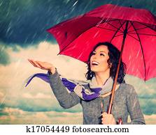 Smiling Woman with Umbrella over Autumn Rain Background Smiling Woman with Umbrella over Autumn Rain Background