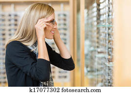 Woman Trying On Eyeglasses In Store