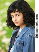 Portrait of a girl with dark, curly hair; Oregon, United States of America