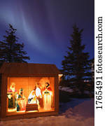 Outdoor Nativity scene under the Northern Lights