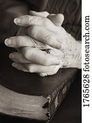 Senior praying with Bible