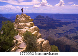 person on top of rock formation