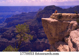 person sitting on rock outcrop