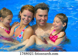 Portrait of a happy family in swimming pool