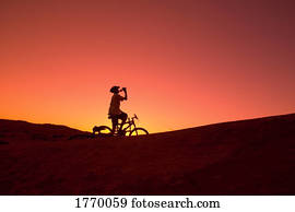 Silhouette person on bike