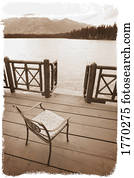 Chair on a deck overlooking a lake