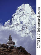Mountain peak in the clouds behind cultural monument