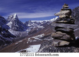 Mountainous terrain with stone monument in foreground