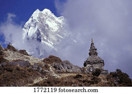 Snow covered peak with cultural monument in forefront