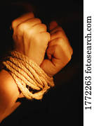 Wrists bound by rope