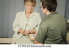 A physiotherapist talks to a patient