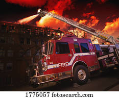 Fire fighters and fire truck putting out fire