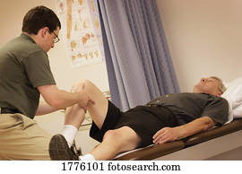 Man having leg stretched