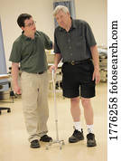 Physiotherapist helping a patient to walk