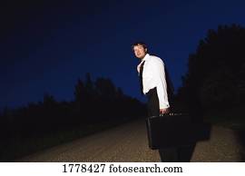 A business person on a gravel road
